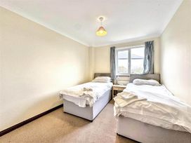 A bedroom with two beds and a window at Porthleven Coastal Retreat with 5 Bedrooms Porthleven