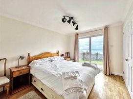 A bedroom with a bed and bedside table at Porthleven Coastal Retreat with 5 Bedrooms Porthleven