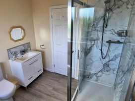 A bathroom with a vanity sink, toilet and shower at Porthleven Coastal Retreat with 5 Bedrooms in Porthleven