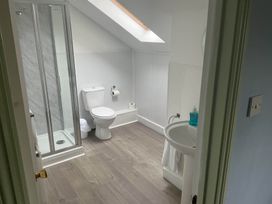 A bathroom with a shower, toilet, and sink at Porthleven Coastal Retreat with 5 Bedrooms, Porthleven