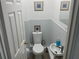 A bathroom with a toilet and sink at Porthleven Coastal Retreat with 5 Bedrooms Porthleven