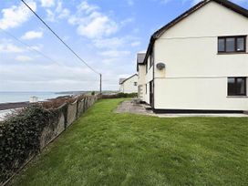 A house with grass and fence at Porthleven Coastal Retreat with 5 Bedrooms in Porthleven