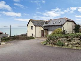 A house with a driveway and view of the sea at Porthleven Coastal Retreat with 5 Bedrooms in Porthleven