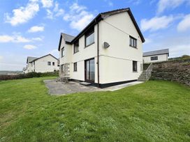 A house with patio and lawn at Porthleven Coastal Retreat with 5 Bedrooms in Porthleven