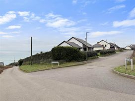 A view of houses and ocean along the road at Porthleven Coastal Retreat with 5 Bedrooms Porthleven