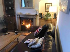 A living room with a fireplace and a sofa at Beautiful Sea Front Cottage in Plymouth
