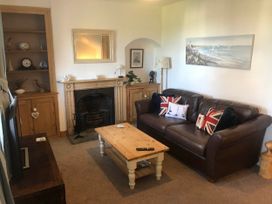 A living room with a sofa and a coffee table at Beautiful Sea Front Cottage in the Ocean City, Plymouth
