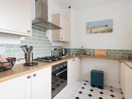 A kitchen with a stove and kettle at Beautiful Sea Front Cottage in the Ocean City Plymouth