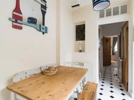 A dining room with a wooden table and chairs at Beautiful Sea Front Cottage in Plymouth