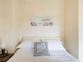 A bedroom with a bed and a lamp at Beautiful Sea Front Cottage in Plymouth