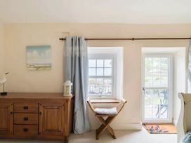 A room with a chest of drawers and a window at Beautiful Sea Front Cottage in Plymouth