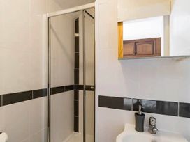 A bathroom with a shower and sink at Beautiful Sea Front Cottage in Plymouth