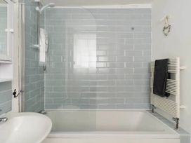 A bathroom with a bathtub and shower at Beautiful Sea Front Cottage in Plymouth