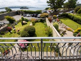 An outdoor area with a garden and parking lot at Beautiful Sea Front Cottage in Plymouth
