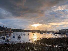 A view of boats on water during sunset at Beautiful Sea Front Cottage in Plymouth