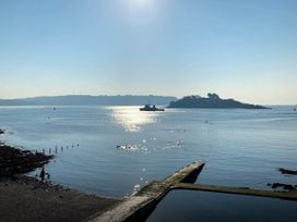 A scenic view of water with an island and boat at Beautiful Sea Front Cottage in Plymouth