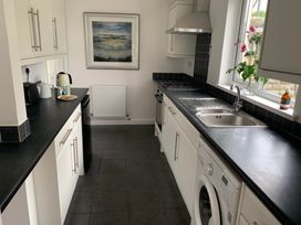 A kitchen with a sink and washing machine at 2 Bed Sleeps 4 Parking Pets 10 min walk to Beach in Falmouth