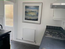 A kitchen with a gas stove and a framed picture at 2 Bed Sleeps 4 Parking Pets 10 min walk to Beach Falmouth