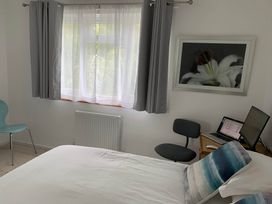 A bedroom with a bed, chair, and computer at 2 Bed Sleeps 4 Parking Pets 10 min walk to Beach Falmouth