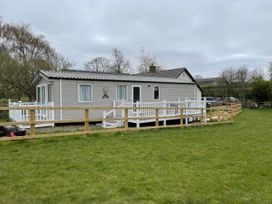 A caravan with a porch and fenced area at Caravan in Holcot Sleeps 6 Max 6 people Max 4 adults per booking Pet Friendly Holcot near Moulton