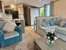 A living room with sofa and dining area at Caravan in Holcot Sleeps 6 Max 6 people Max 4 adults per booking Pet Friendly Holcot near Moulton