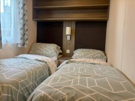 A bedroom with two single beds at Caravan in Holcot Sleeps 6 Max 6 people Max 4 adults per booking Pet Friendly Holcot near Moulton