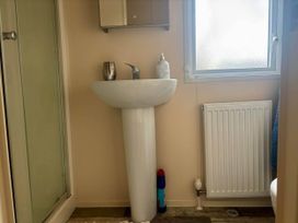 A bathroom with a sink and mirror at Caravan in Holcot Sleeps 6 Max 6 people Max 4 adults per booking Pet Friendly Holcot near Moulton