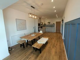 A dining room with a wooden table and benches at Aberporth 2 Bed Cottage Sleeps 4 Pet Friendly Parcllyn near Aberporth