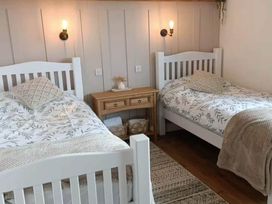A bedroom with two beds and a nightstand at Aberporth 2 Bed Cottage Sleeps 4 Pet Friendly, Parcllyn near Aberporth