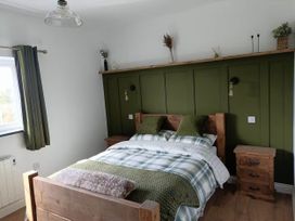 A bedroom with a bed and wooden furniture at Aberporth 2 Bed Cottage Sleeps 4 Pet Friendly Parcllyn near Aberporth