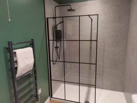 A bathroom with a shower enclosure and towel rack at Aberporth 2 Bed Cottage Sleeps 4 Pet Friendly Parcllyn near Aberporth