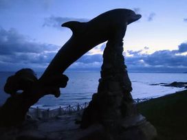 A dolphin statue near the sea at Aberporth 2 Bed Cottage Sleeps 4 Pet Friendly Parcllyn near Aberporth