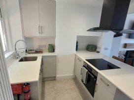 A kitchen with sink and hob at Looe Cottage Seaside views log fire sleeps 4 in Looe