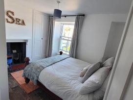 A bedroom with a bed and window at Looe Cottage Seaside views log fire sleeps 4 in Looe
