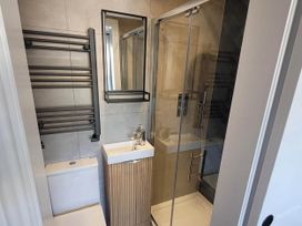 A bathroom with a shower, sink and toilet at Looe Cottage Seaside views log fire sleeps 4 in Looe