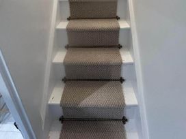 A stairway with carpeted steps at Looe Cottage Seaside views log fire sleeps 4 in Looe