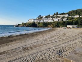 A beach with houses on a hillside at Looe Cottage Seaside views log fire sleeps 4 in Looe