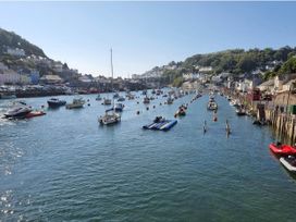 A waterway with boats and buildings at Looe Cottage Seaside views log fire sleeps 4 Looe