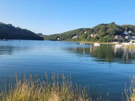 A lake with boats and hills at Looe Cottage Seaside views log fire sleeps 4 Looe