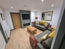 A living room with a television and sofas at Conwy Charm Cottage 3 Bed Retreat Penmaenmawr