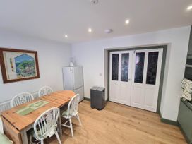 A kitchen with a table and chairs at Conwy Charm Cottage 3 Bed Retreat in Penmaenmawr
