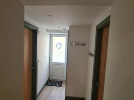 A hallway with coat hooks and a door at Conwy Charm Cottage 3 Bed Retreat in Penmaenmawr