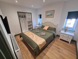 A bedroom with a bed and wardrobe at Conwy Charm Cottage 3 Bed Retreat in Penmaenmawr