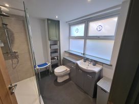 A bathroom with a shower, toilet, and sink at Conwy Charm Cottage 3 Bed Retreat in Penmaenmawr