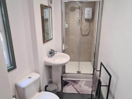 A bathroom with a sink, toilet, and shower at Conwy Charm Cottage 3 Bed Retreat Penmaenmawr