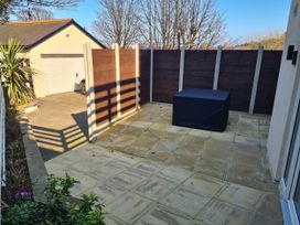 An outdoor area with paving, a storage box, and a fence at Conwy Charm Cottage 3 Bed Retreat Penmaenmawr