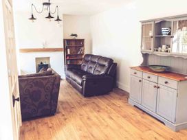 A living room with a sofa and bookcase at 3Bed Cottage Plymouth Dog friendly Sleeps7 in Plymouth