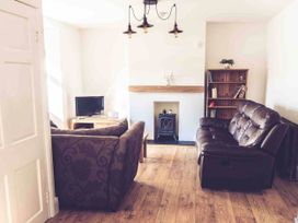 A living room with a sofa, coffee table, television and fireplace at 3Bed Cottage Plymouth Dog friendly Sleeps7 Plymouth
