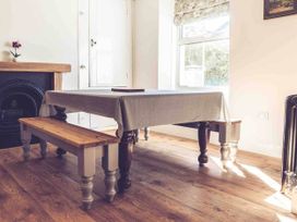 A dining room with a table and benches at 3Bed Cottage Plymouth Dog friendly Sleeps7 in Plymouth