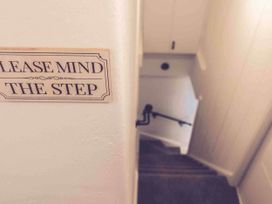 A staircase with a sign saying please mind the step at 3Bed Cottage Plymouth Dog friendly Sleeps7 Plymouth